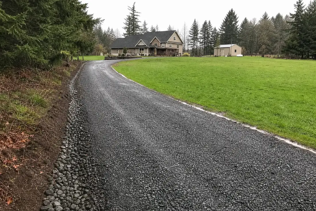 New crushed-rock gravel driveway with drainage on a rural Hillsboro, OR property